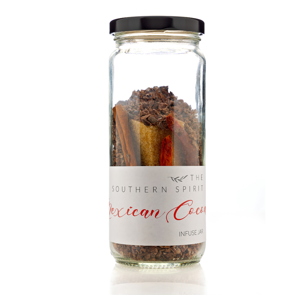 A close up photo of a cocktail infusion jar - Mexican Cocoa Includes: Vanilla-Infused Organic NonGMO Sugar, Cocoa Nibs, Cinnamon, and Chile de Árbol Pepper. (it's Cayenne's cousin)